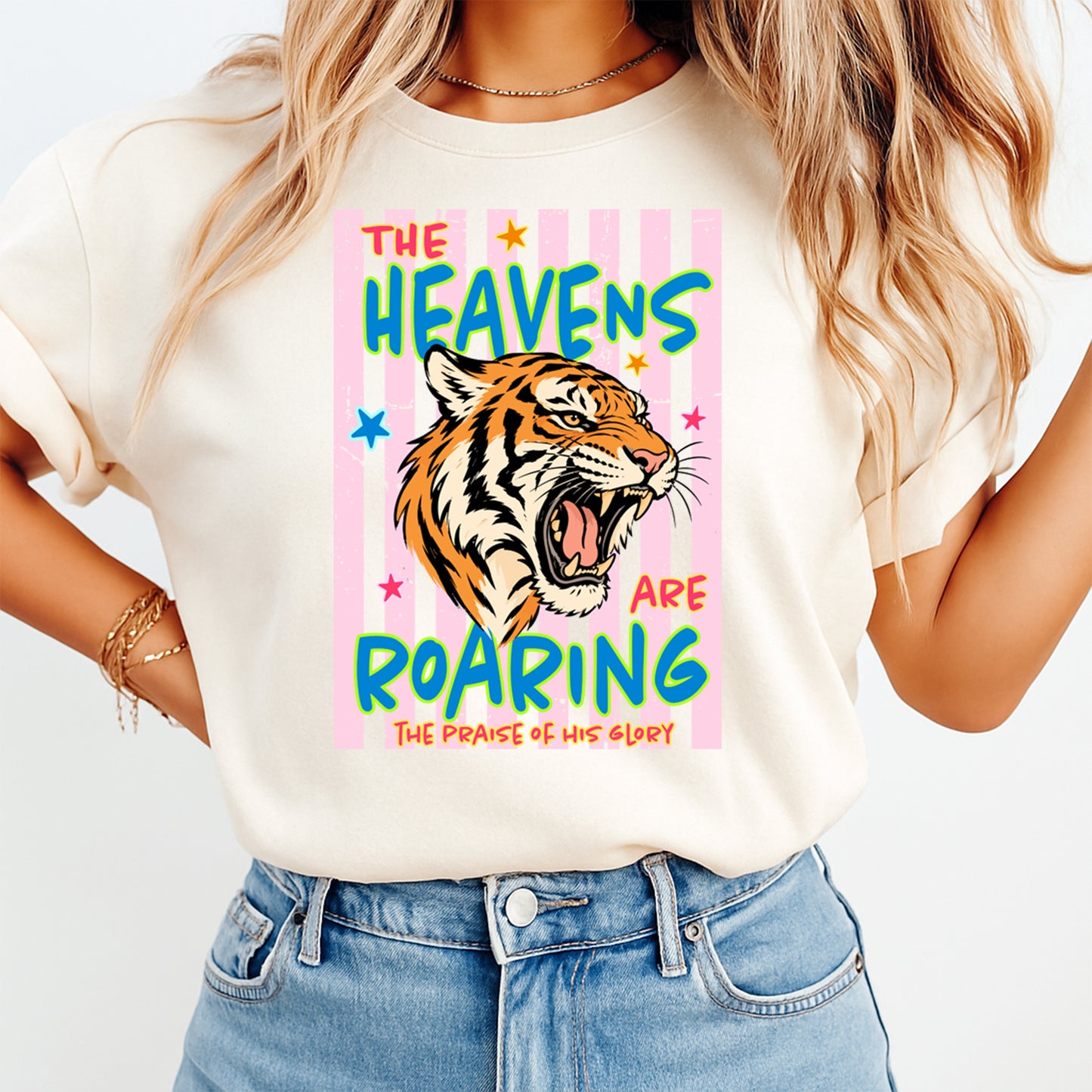 Person wearing a t-shirt with a tiger graphic and text on a white background