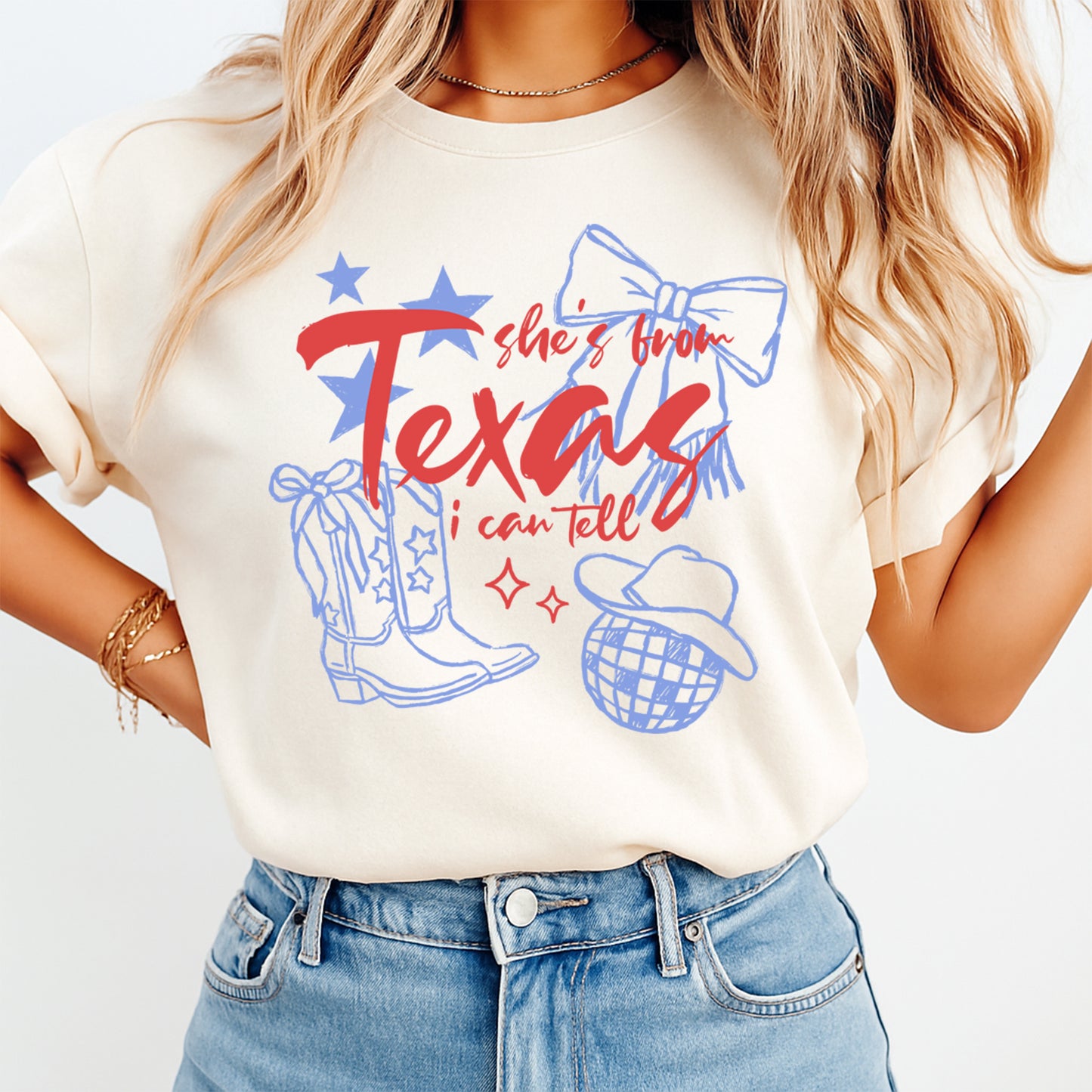 Person wearing a white t-shirt with 'she's from Texas, I can tell' graphic design.