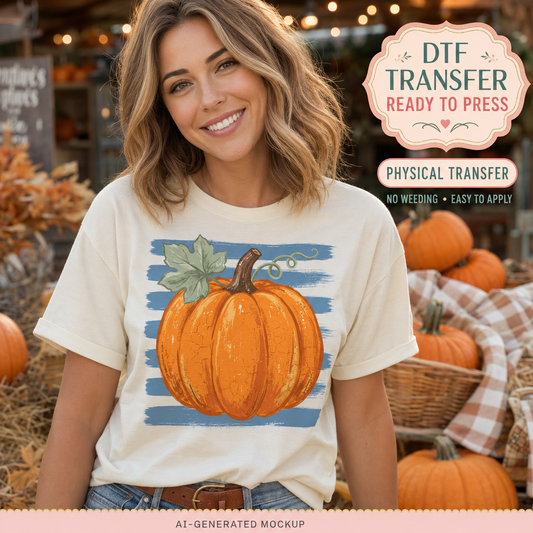 Fall pumpkin DTF transfer with a rustic orange pumpkin and distressed blue stripes displayed on a cream women’s T-shirt mockup