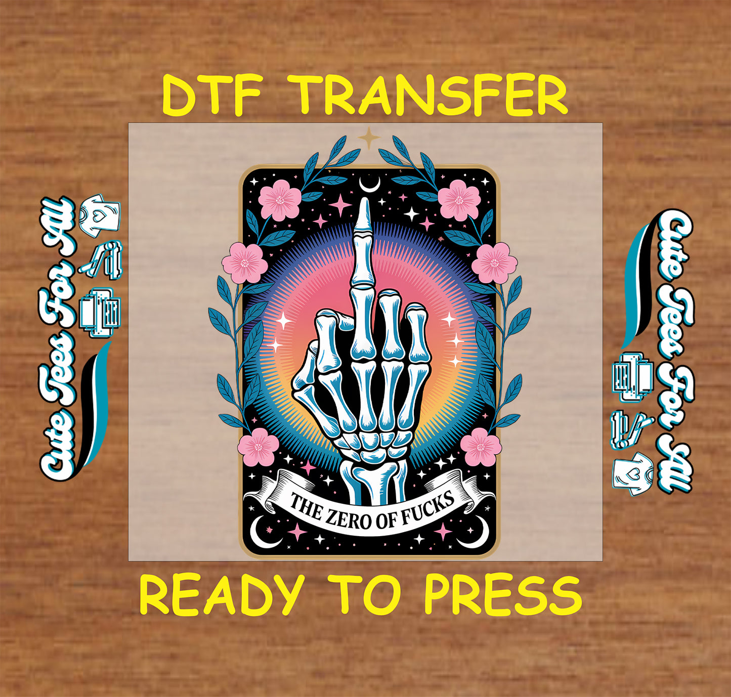 A graphic preview of a DTF (Direct to Film) transfer design, showing a central tarot card illustration with a skeletal hand making the middle finger, surrounded by pink flowers and blue leaves. The text 'DTF TRANSFER' is written in yellow at the top, and 'READY TO PRESS' at the bottom, with black and blue machine graphics on the left and right sides, all set against a brown wood-grain background.