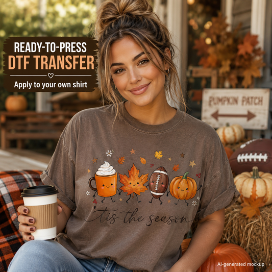 A woman wearing a brown graphic t-shirt with a fall-themed design, sitting in a cozy autumn-themed setting with pumpkins and a coffee cup. Text overlays indicate it is a ready-to-print DTF transfer mockup.