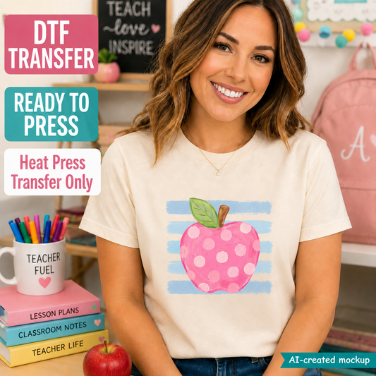 A woman wearing a cream-colored t-shirt with a graphic of a pink polka-dotted apple on a light blue striped background. The image is a digital mockup with text overlays reading 'DTF TRANSFER', 'READY TO PRESS', and 'Heat Press Transfer Only', set against a classroom-themed background.
