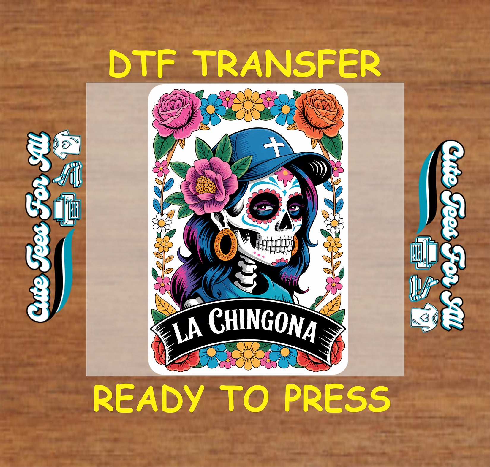 A colorful Day of the Dead style graphic transfer design centered on a tan rectangular sheet, with yellow text reading 'DTF TRANSFER' at the top and 'READY TO PRESS' at the bottom on a wood background. The artwork shows a stylized skull wearing a blue hat, surrounded by pink, orange, yellow, and blue flowers, with the words 'LA CHINGONA' on a black banner.