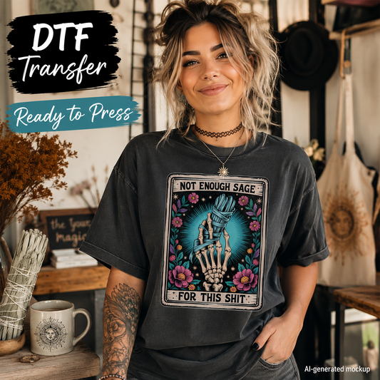 Woman wearing a black shirt with the funny Not Enough Sage tarot card DTF transfer featuring a skeleton hand and flowers.