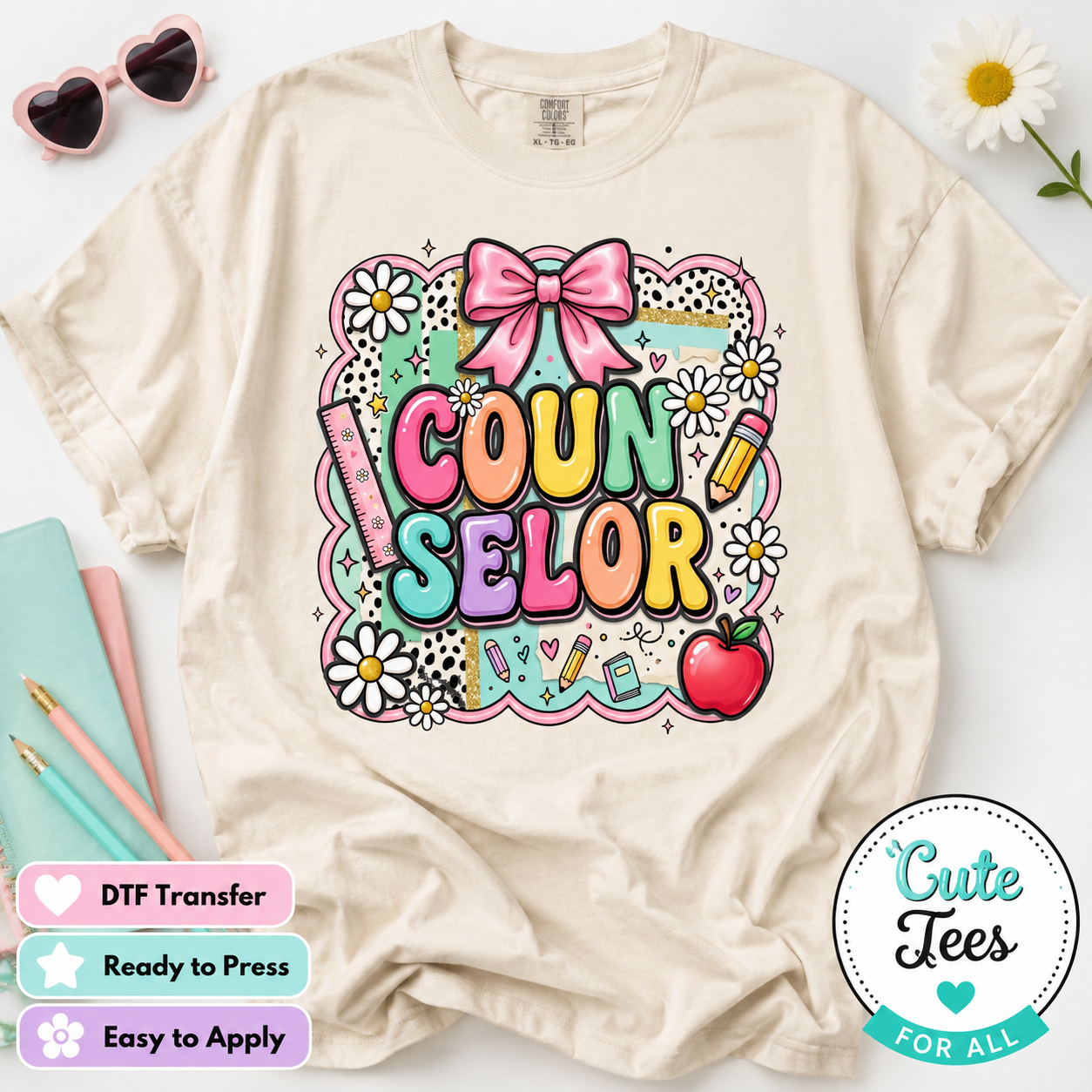 A cream-colored t-shirt with a colorful 'Counselor' DTF transfer graphic, styled in a flat-lay with decorative props including sunglasses, a daisy, notebooks, and pencils. Promotional badges for 'Cute Tees' are visible on the bottom right and left.
