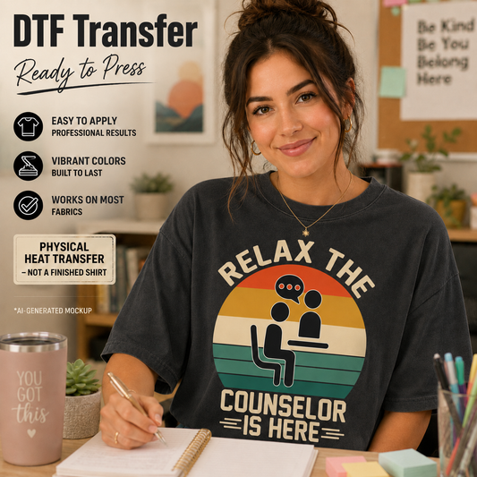 A woman wearing a charcoal gray t-shirt with a retro-style graphic that reads 'RELAX THE COUNSELOR IS HERE' in a yellow, orange, and beige sunset design. The image is a promotional mockup for a DTF (Direct to Film) transfer, featuring text callouts on the left and a desk setting in the background.
