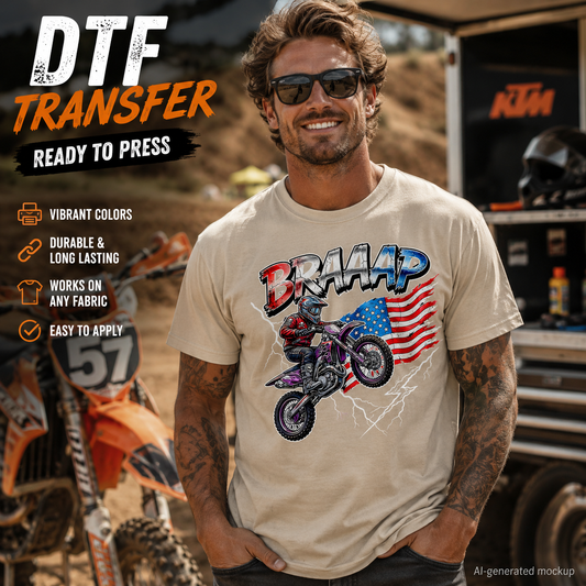 A man wearing a beige t-shirt with a motocross graphic and the word 'BRAAP' in a dusty outdoor setting with an orange dirt bike and a truck in the background. Text overlays on the left describe the t-shirt transfer features.