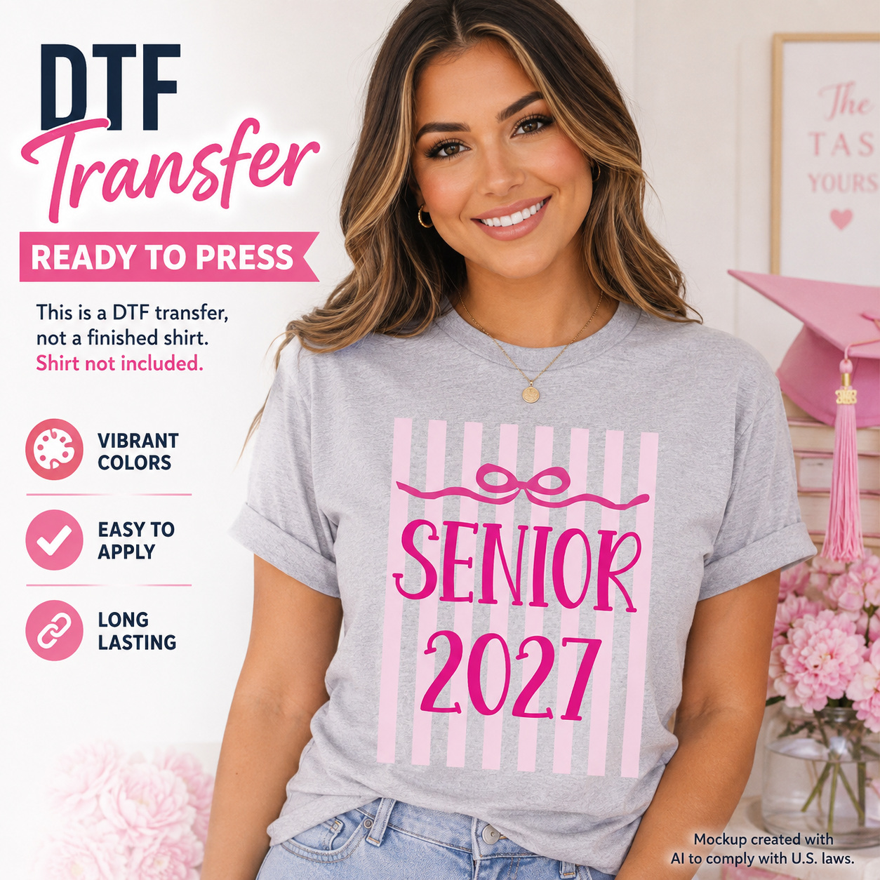 Woman wearing a gray T-shirt featuring a pink Senior 2027 graduation design with vertical pink stripes and a bow accent.