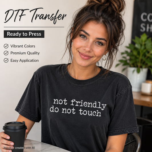 A woman wearing a black graphic T-shirt with the phrase 'not friendly do not touch' in white text, holding a black coffee cup in a cafe setting. Text overlays on the left read 'DTF Transfer', 'Ready to Press', and feature selling points like vibrant colors, premium quality, and easy application.