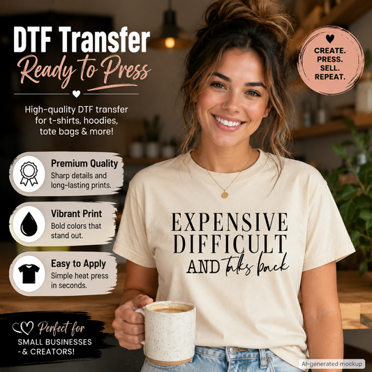 A woman wearing a cream-colored t-shirt with a black graphic print that reads 'EXPENSIVE DIFFICULT AND takes back'. She is holding a coffee mug in a cafe setting, with promotional text overlays on the left and right highlighting the features of a DTF (Direct to Film) transfer.
