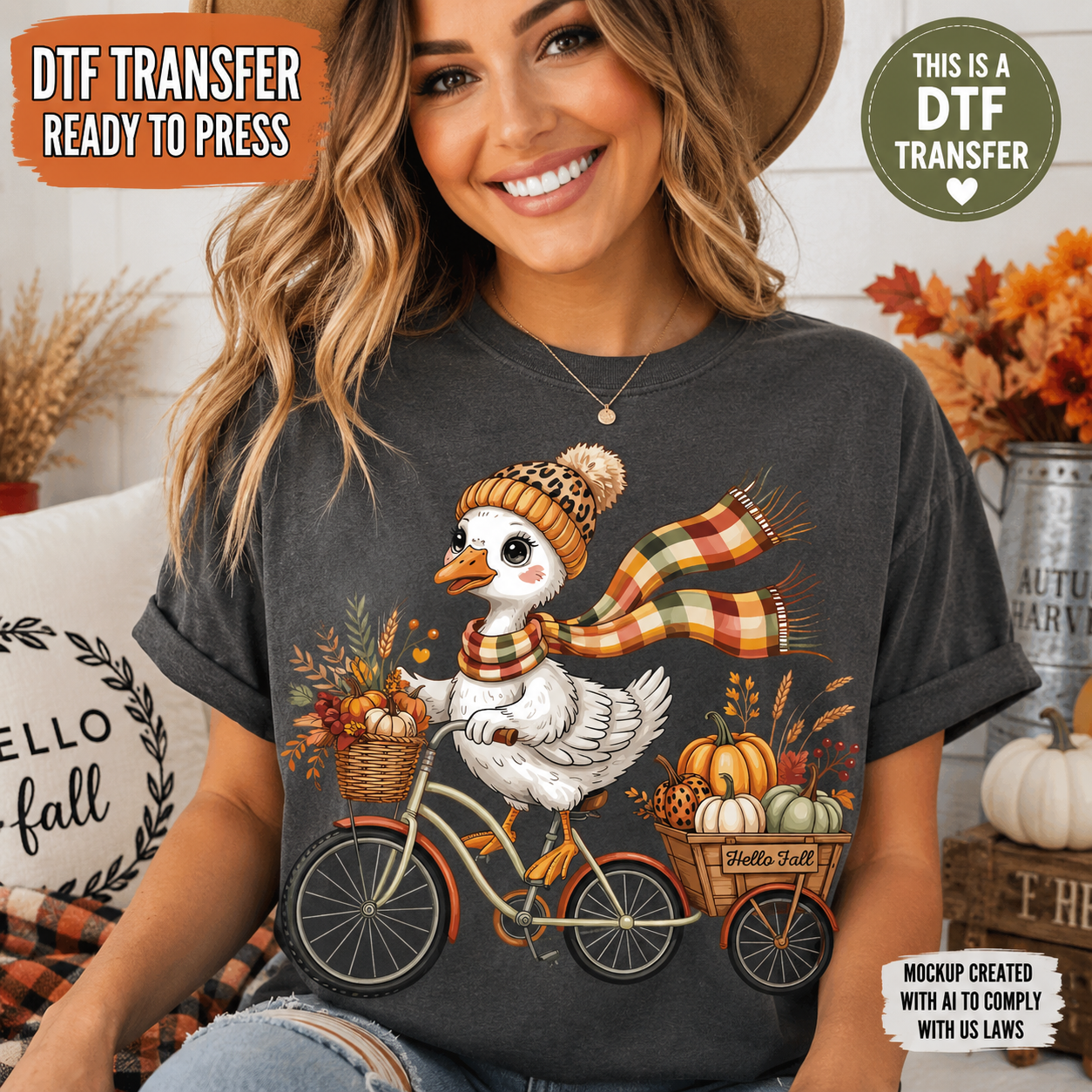 A woman wearing a charcoal gray t-shirt with a graphic of a white duck riding a bicycle with pumpkins and fall decorations. The image includes text overlays reading 'DTF TRANSFER READY TO PRESS' and 'THIS IS A DTF TRANSFER'.