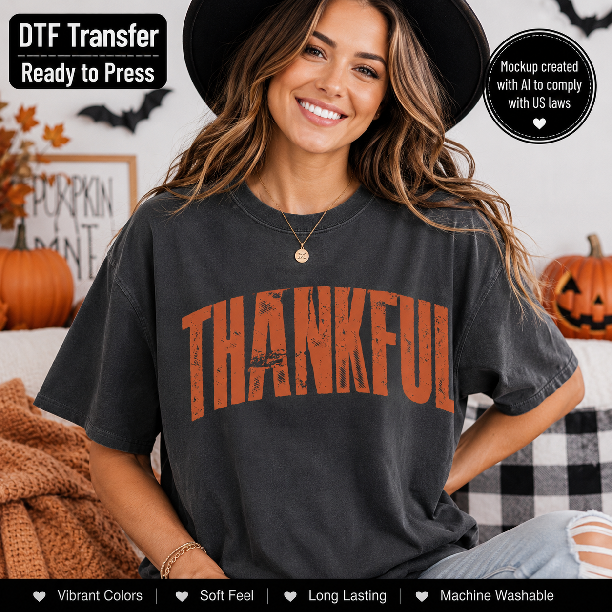 A woman wearing a dark charcoal gray t-shirt with a distressed orange 'THANKFUL' graphic, posed in a cozy Halloween-themed room with pumpkins and a black-and-white checkered couch.