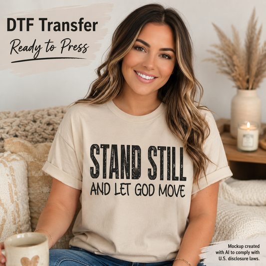 A woman sitting on a couch wearing a beige graphic T-shirt with the text 'STAND STILL AND LET GOD MOVE' in distressed black lettering. The image includes promotional text reading 'DTF Transfer Ready to Press' and a small mockup disclaimer in the lower right corner.