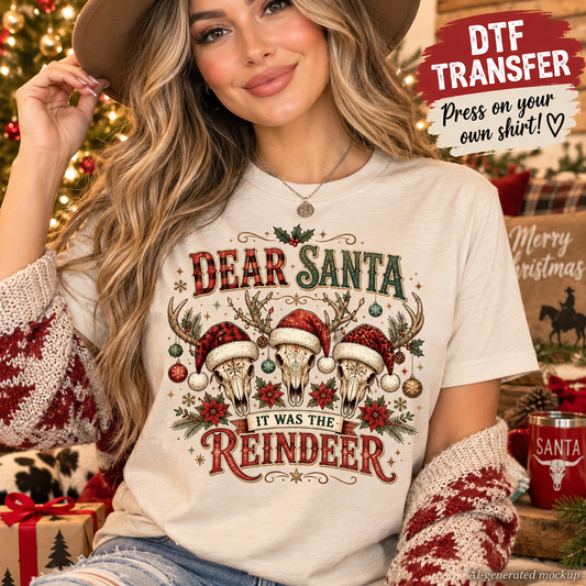 A woman wearing a cream-colored graphic t-shirt with a 'Dear Santa It Was the Reindeer' design, styled with a brown hat and red-and-white knit sweater sleeves, set against a cozy Christmas tree background with promotional text overlays.