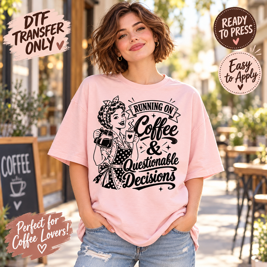 A woman wearing a light pink graphic t-shirt with a black retro-style illustration and the text 'Running on Coffee & Questionable Decisions'. The background is a blurred outdoor cafe setting.