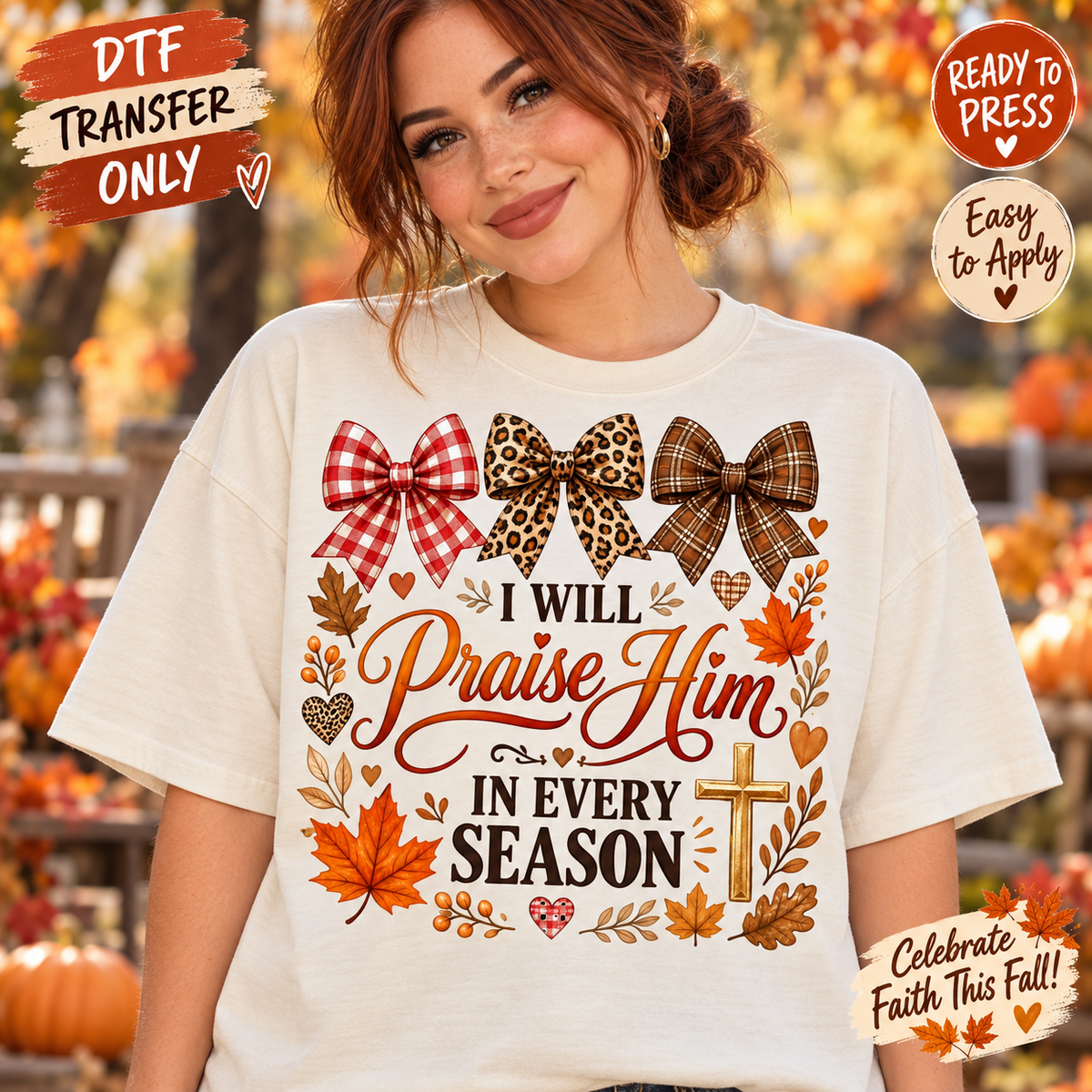 A woman wearing a white graphic T-shirt with autumn-themed bow and leaf designs and the text 'I Will Praise Him In Every Season.' The background shows a blurred fall outdoor scene with pumpkins and foliage.