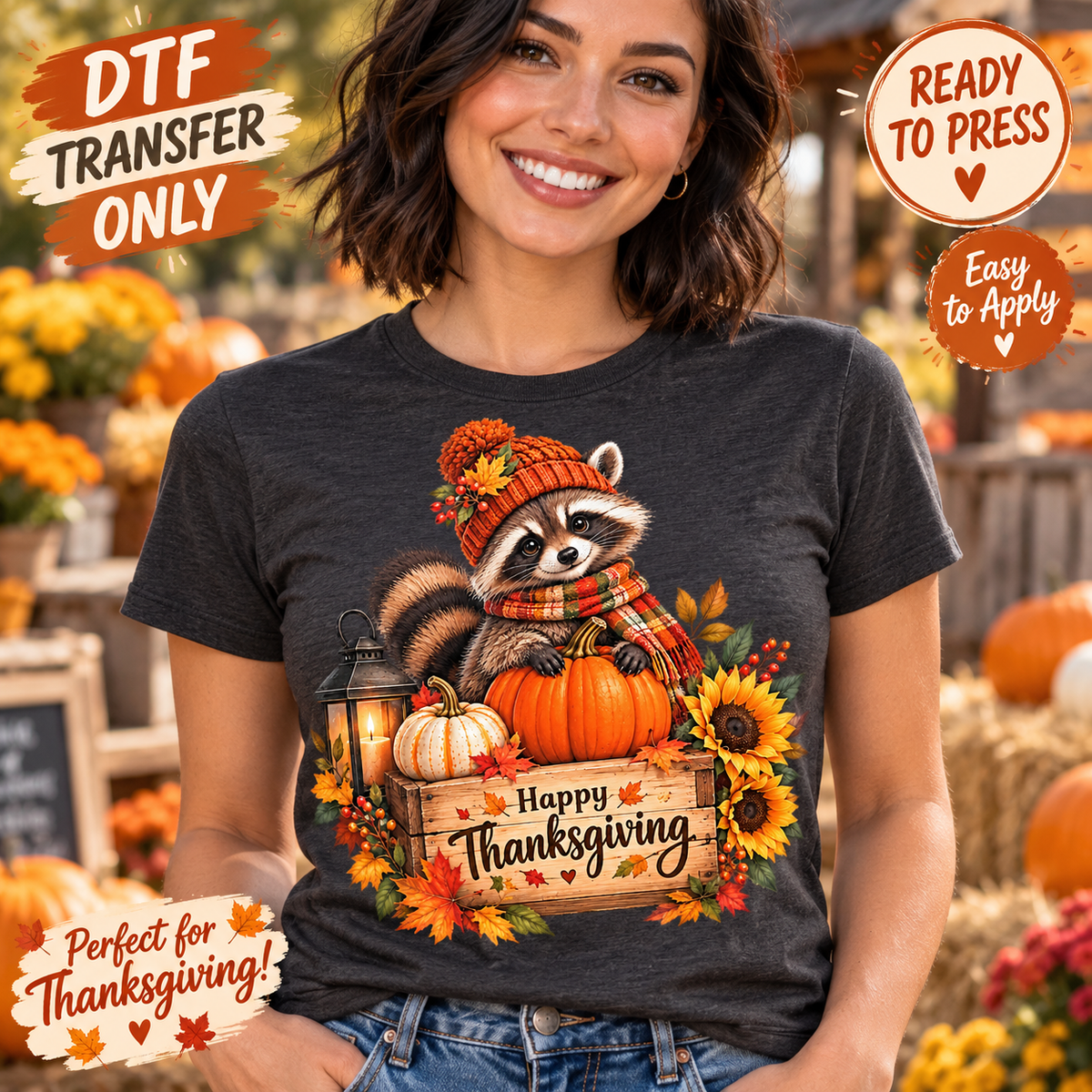 A woman wearing a dark charcoal gray t-shirt with a colorful 'Happy Thanksgiving' raccoon graphic, set against a blurred autumn pumpkin patch background. Promotional badges for 'DTF Transfer Only' and 'Ready to Press' are visible.