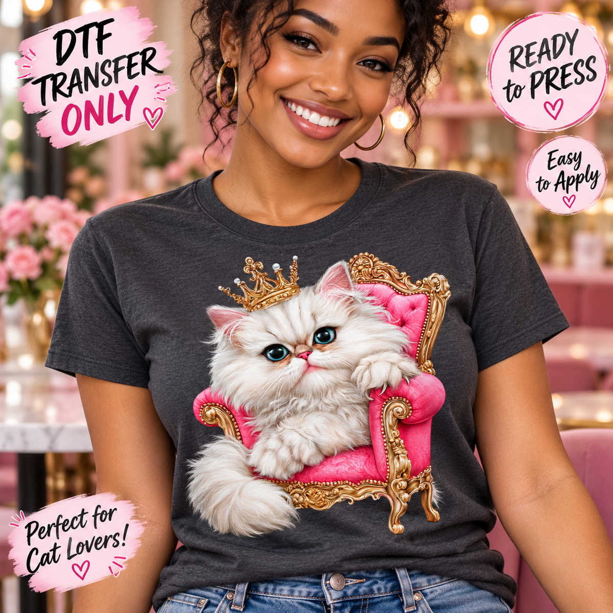 A woman wearing a dark gray t-shirt with a graphic of a fluffy white cat sitting on a pink throne with a gold crown. The image includes promotional text overlays for a DTF transfer product.