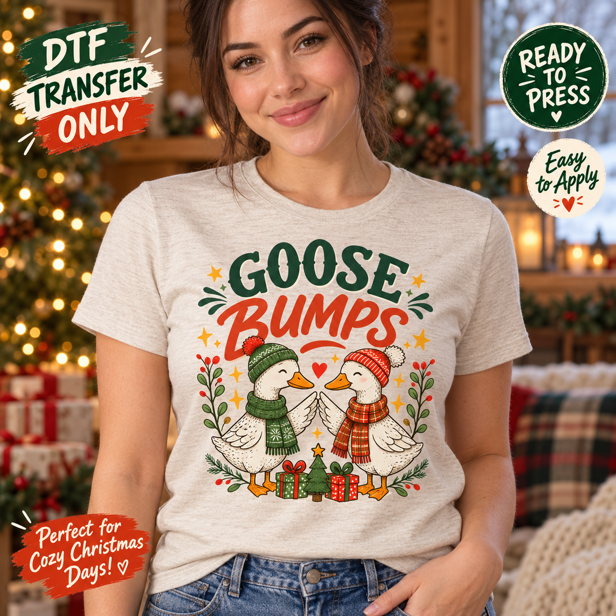Woman in a light heather tee modeling Goose Bumps Christmas DTF artwork with two geese touching wings in winter hats and scarves above gifts.