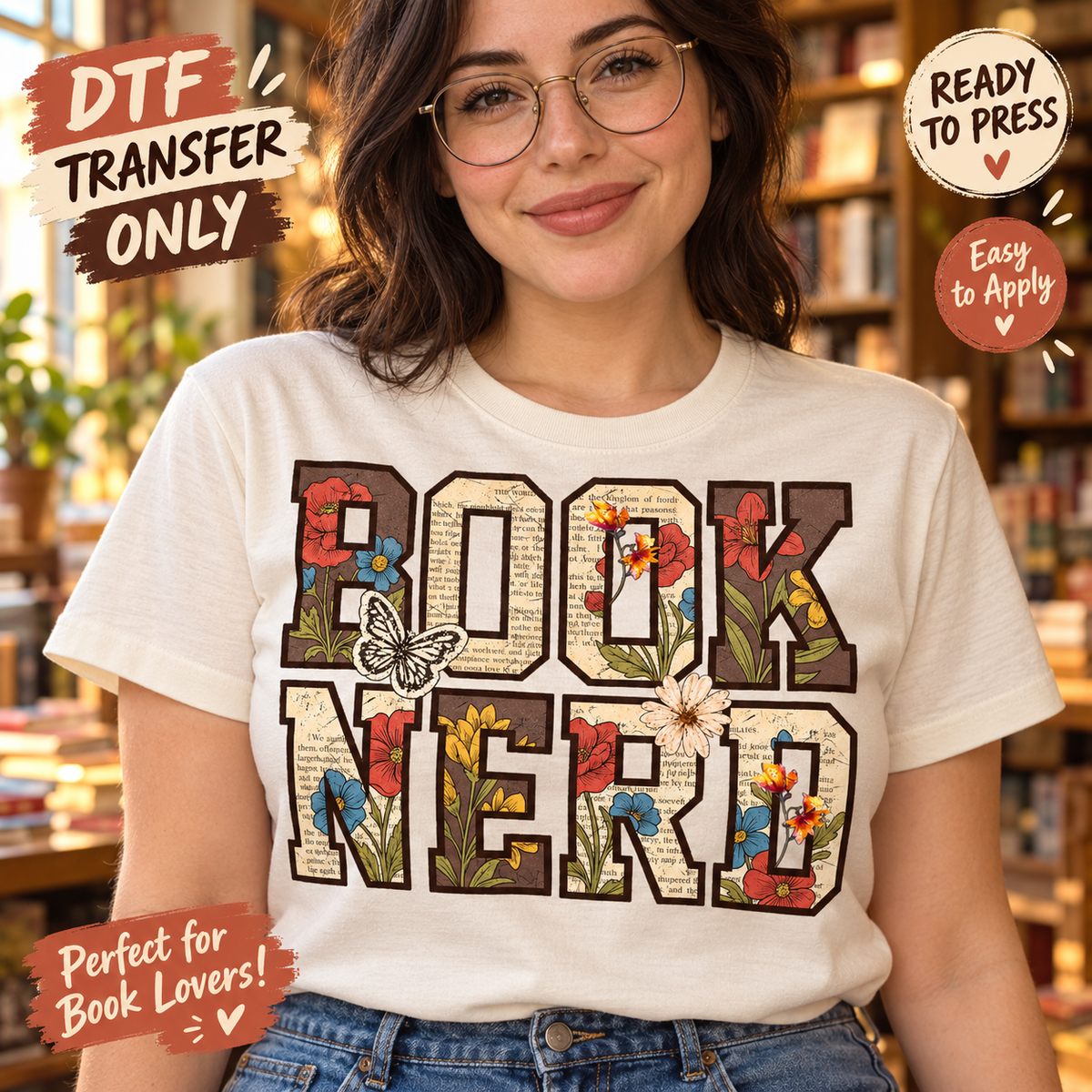 Woman in a cream tee modeling Book Nerd DTF block lettering with book-page textures, red and blue flowers, and a butterfly.