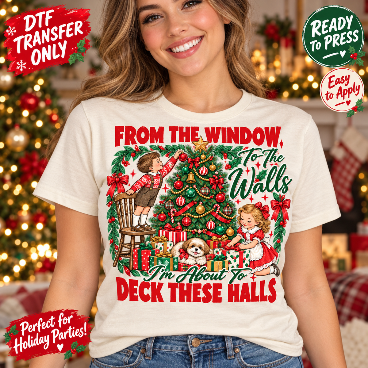 Woman in a cream tee modeling Deck These Halls Christmas DTF artwork with children decorating a tree, wrapped gifts, and a small dog.