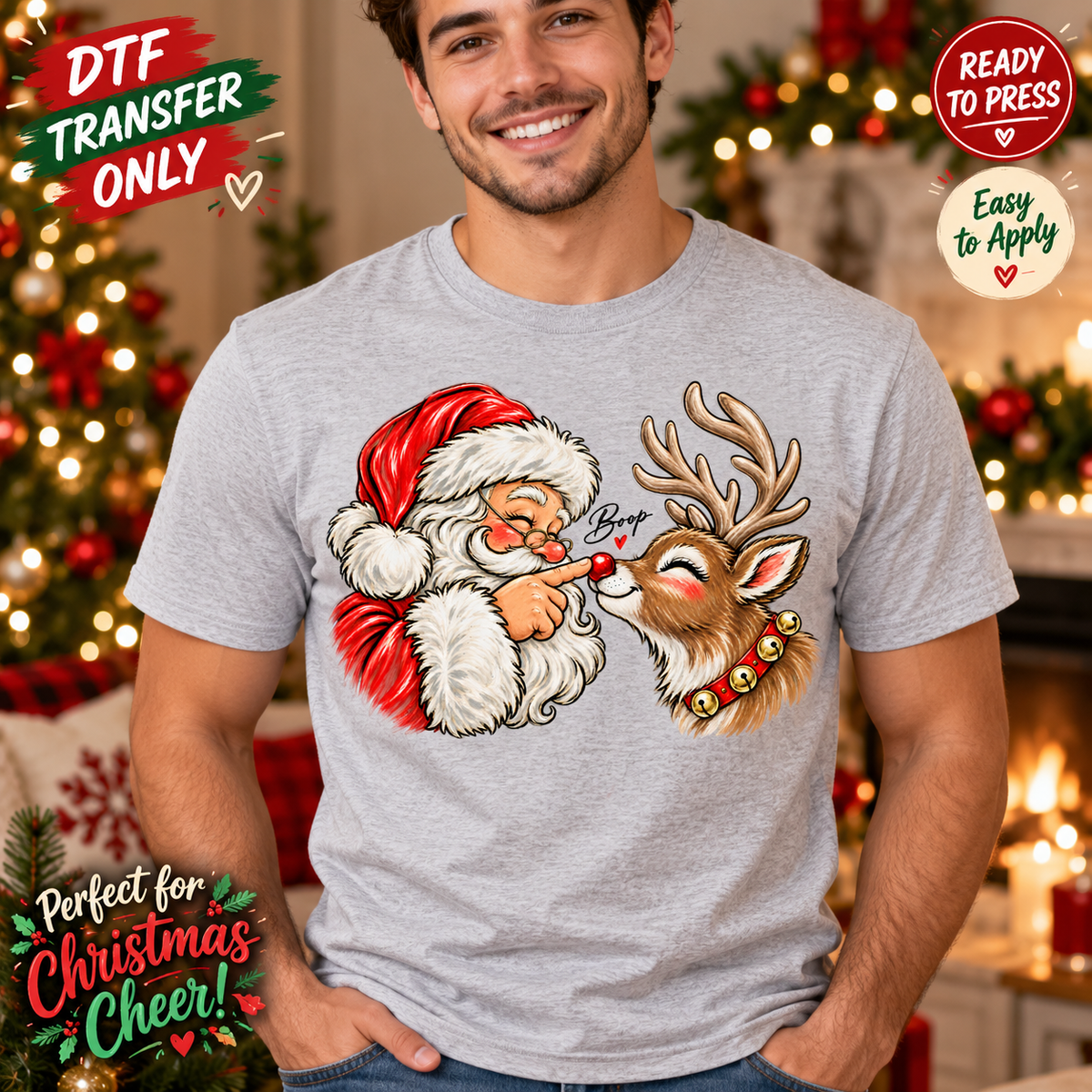 Man in a heather grey shirt showing Santa touching a smiling reindeer's red nose with small Boop lettering; Christmas DTF transfer-only mockup.