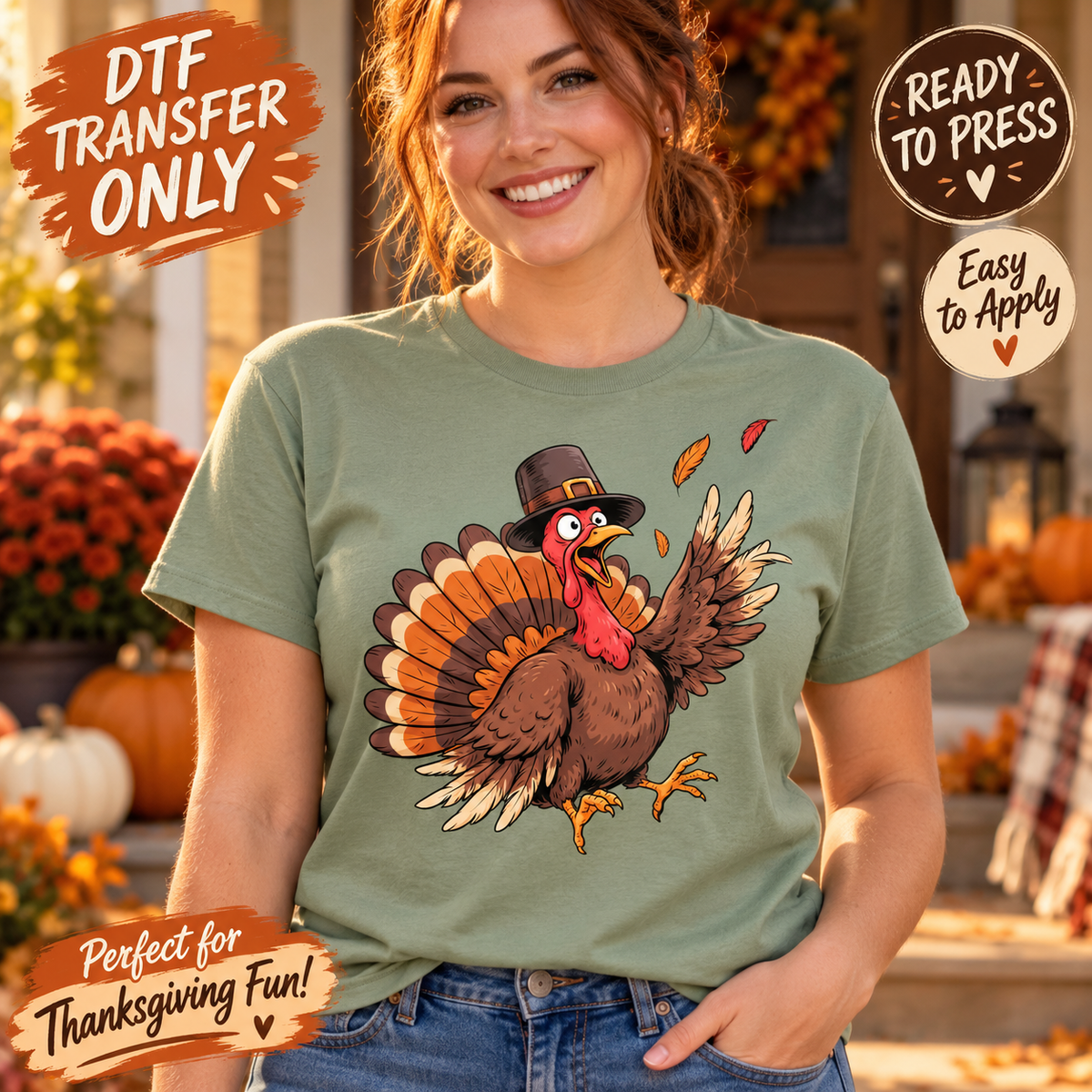 Woman modeling a sage green shirt with a cartoon turkey in a pilgrim hat waving one wing among falling autumn leaves; Thanksgiving DTF transfer mockup.