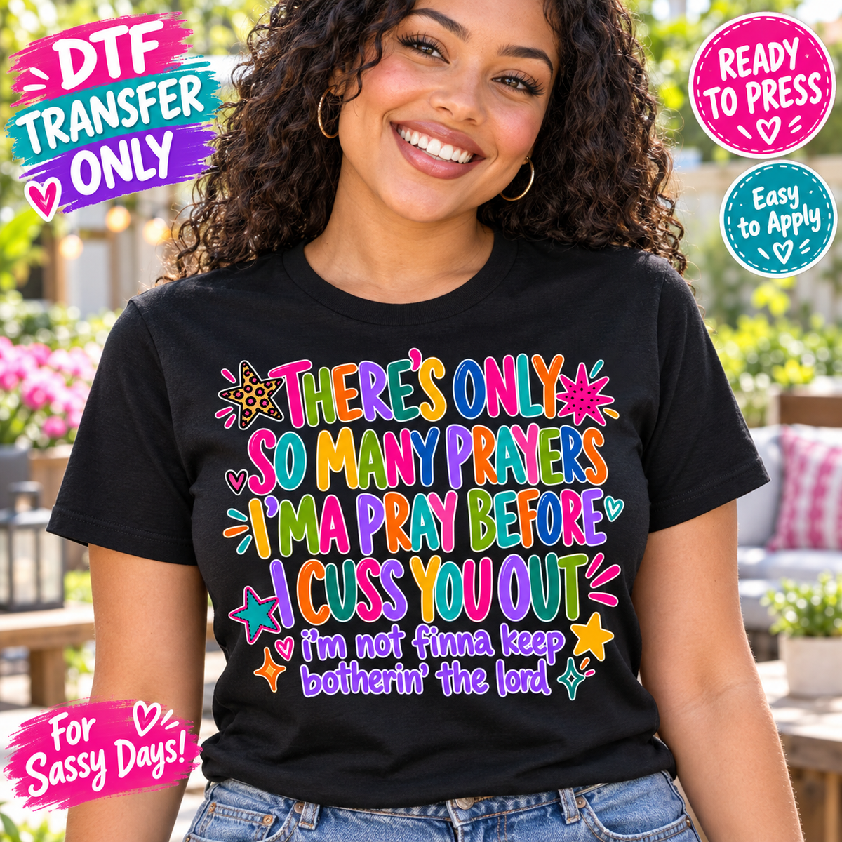 Woman in a black shirt displaying a colorful Only So Many Prayers joke about cussing, with stars and small hearts.