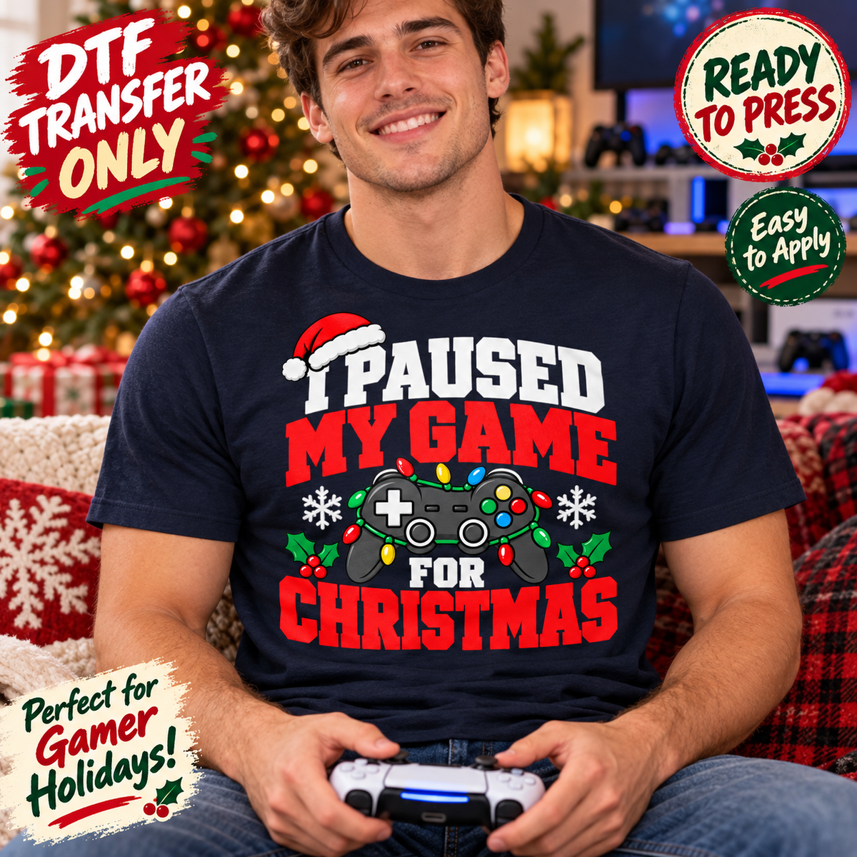 Man in a navy shirt displaying I Paused My Game for Christmas lettering, a controller, holiday lights, and a Santa hat.