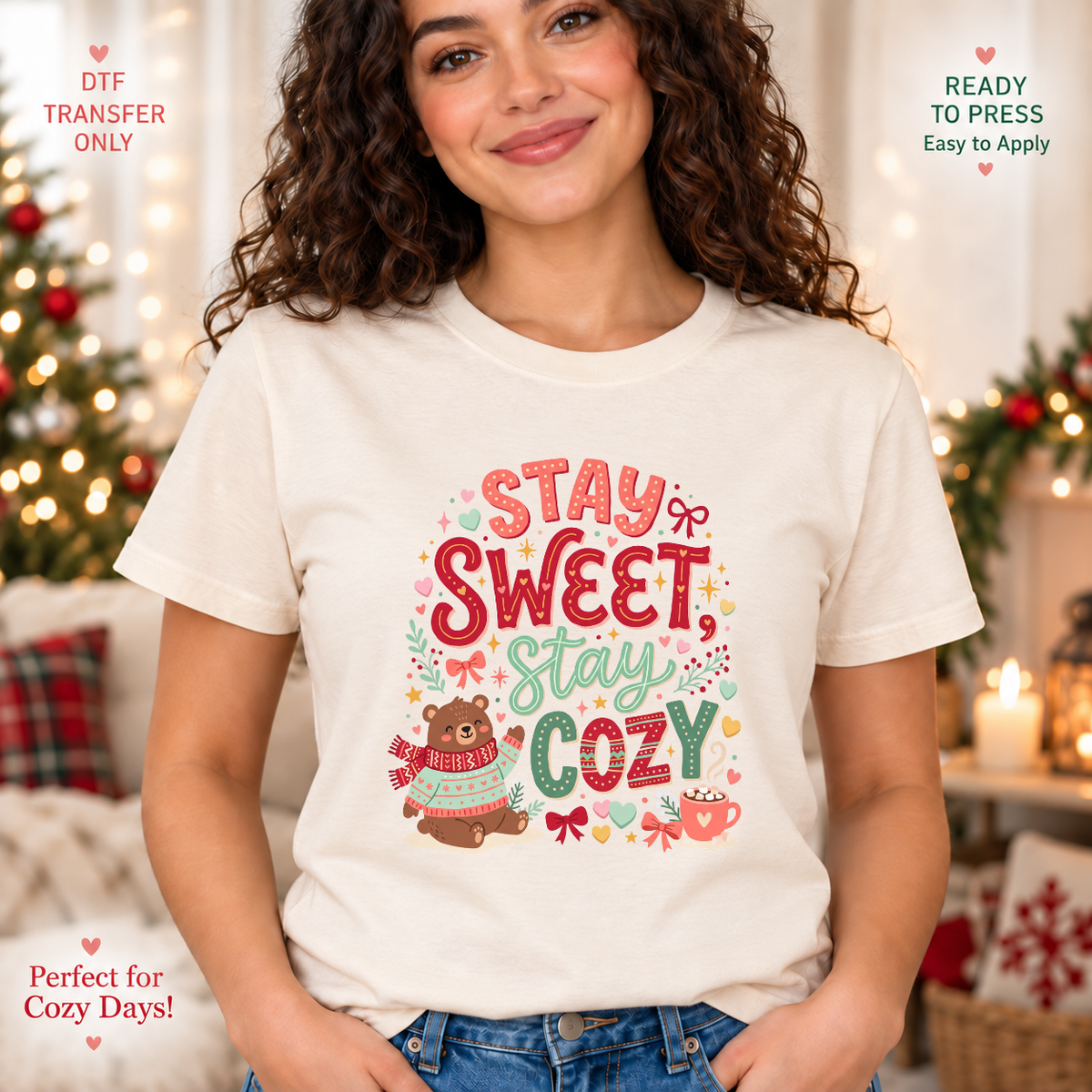 Lifestyle mockup of a woman wearing a cream shirt showing Stay Sweet Stay Cozy lettering with a bear in winter clothing and little hearts. DTF transfer only; shirt not included.