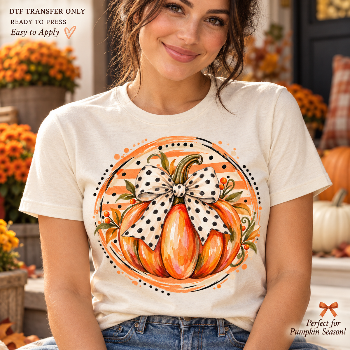 Lifestyle mockup of a woman wearing a cream shirt showing Watercolor orange pumpkin with polka dot bow inside a round orange decorative backdrop. DTF transfer only; shirt not included.