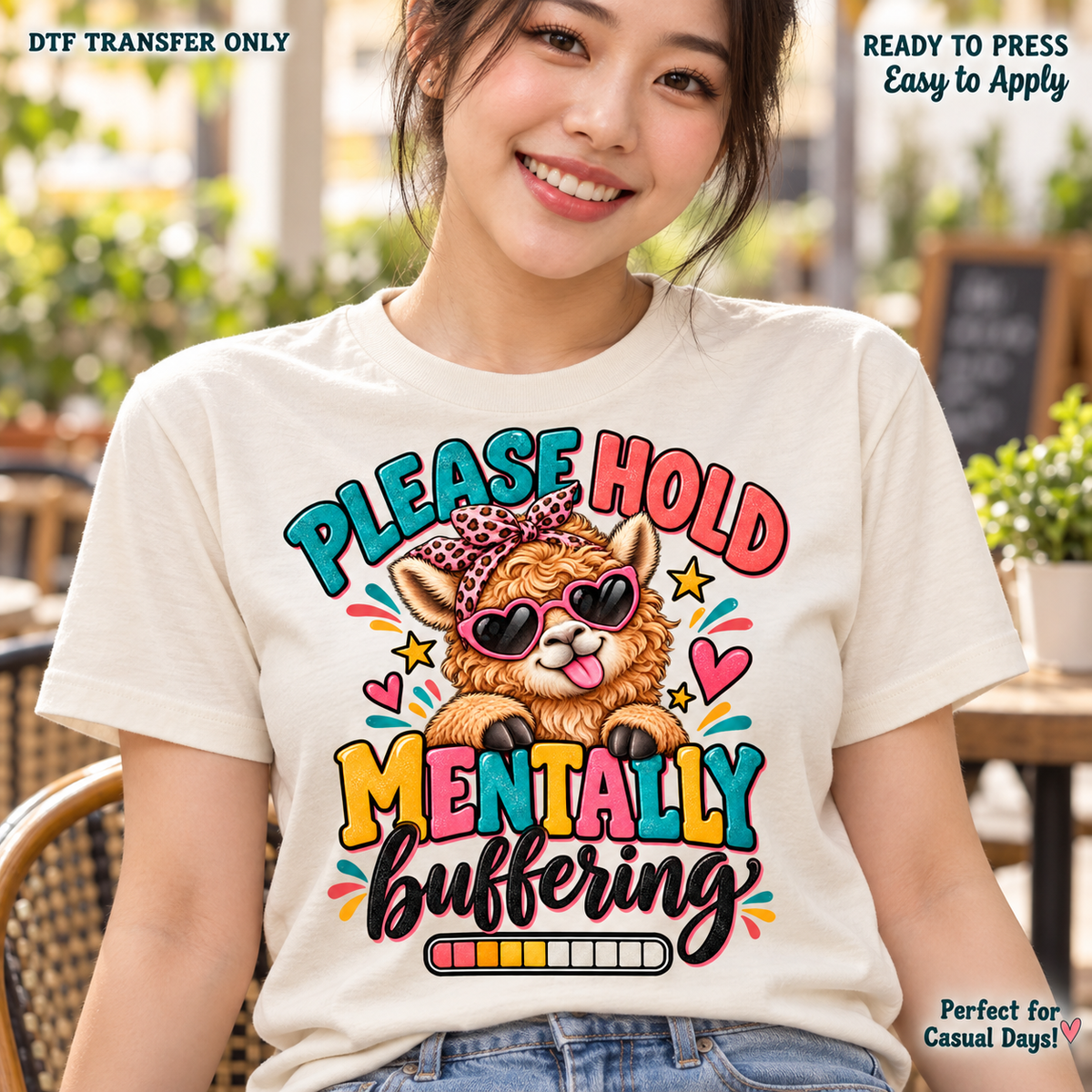 Lifestyle mockup of a woman wearing a cream shirt showing Please Hold Mentally Buffering message with Highland cow, heart sunglasses, leopard bow, and loading bar. DTF transfer only; shirt not included.