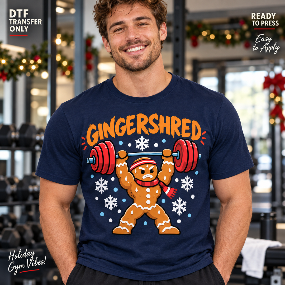 Lifestyle mockup of a man wearing a navy shirt showing Gingershred lettering with gingerbread character lifting a red barbell and white snowflakes. DTF transfer only; shirt not included.