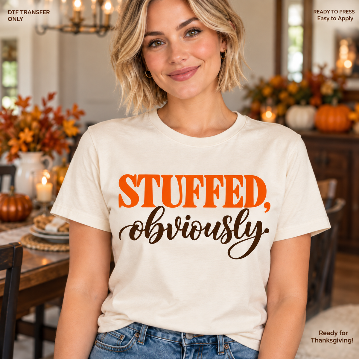 Lifestyle mockup of a woman wearing a cream shirt showing Stuffed Obviously in orange block letters and black script. DTF transfer only; shirt not included.