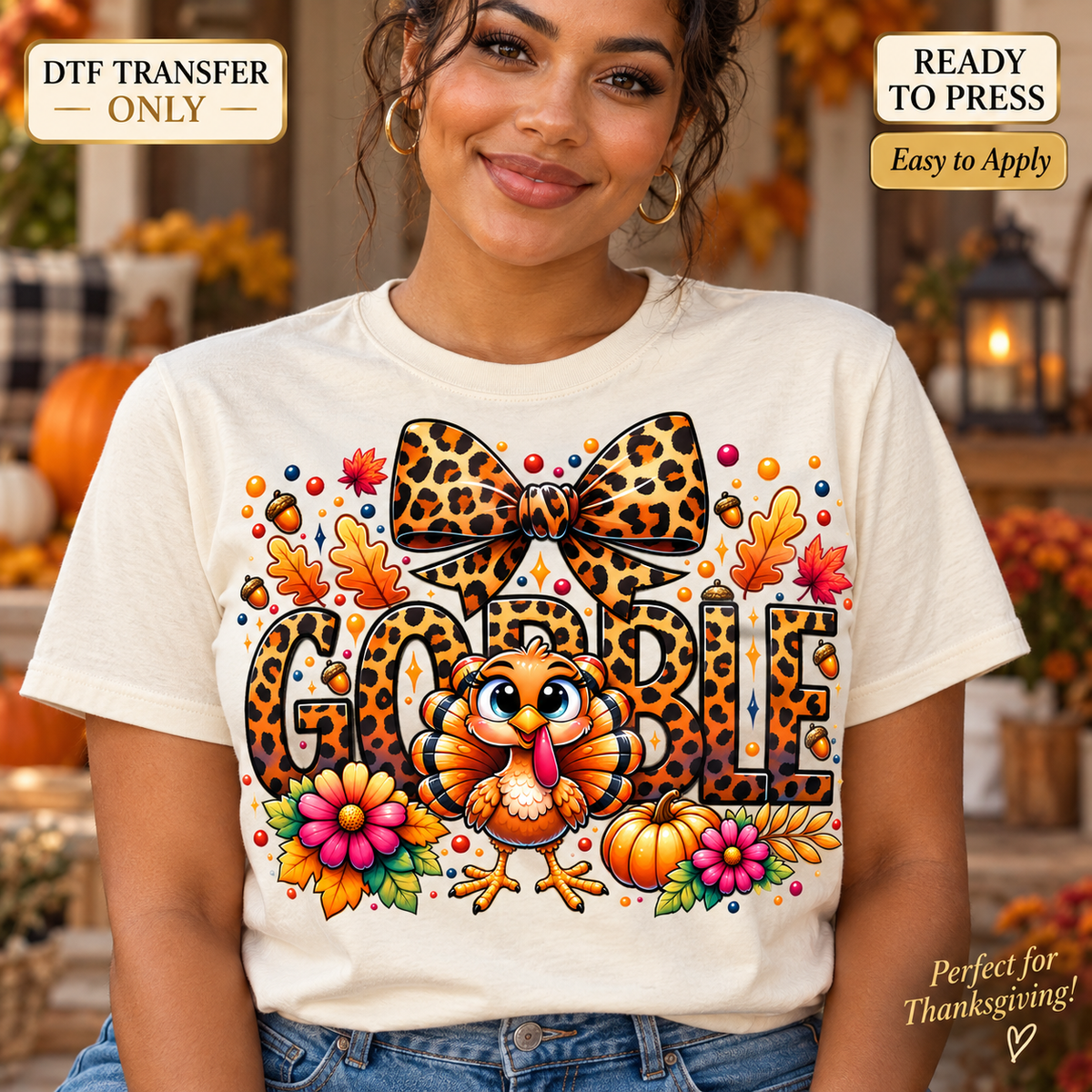 Lifestyle mockup of a woman wearing a cream shirt showing Gobble leopard-print lettering with a leopard bow, smiling turkey, pumpkins, and colorful flowers. DTF transfer only; shirt not included.