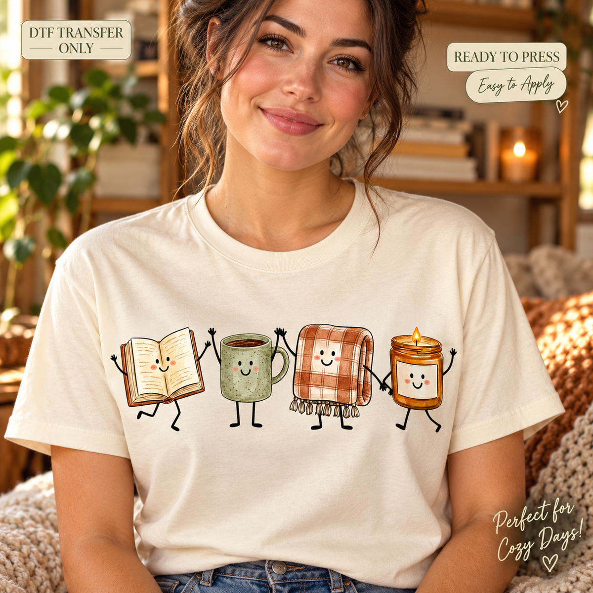 Lifestyle mockup of a woman wearing a cream shirt showing Smiling open book, green mug, plaid blanket, and candle characters. DTF transfer only; shirt not included.
