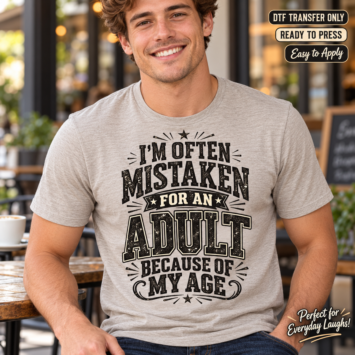 Lifestyle mockup of a man wearing a heather grey shirt showing I'm Often Mistaken for an Adult Because of My Age in distressed black lettering. DTF transfer only; shirt not included.