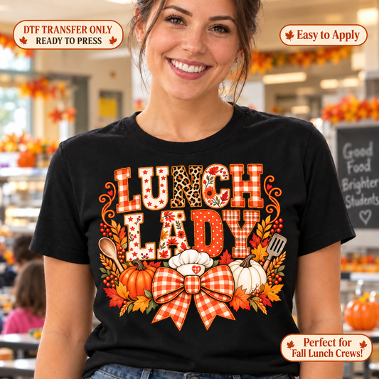 Lifestyle mockup of a woman wearing a black shirt showing Lunch Lady patterned lettering with pumpkins, utensils, leaves, and an orange checked bow. DTF transfer only; shirt not included.