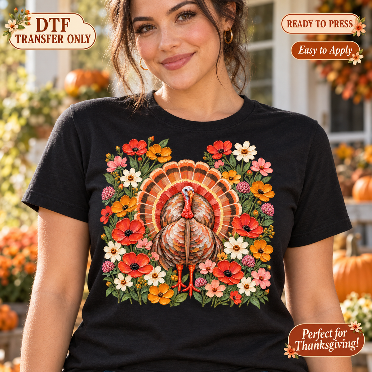 Lifestyle mockup of a woman wearing a black shirt showing Turkey with fanned orange tail surrounded by colorful autumn flowers. DTF transfer only; shirt not included.