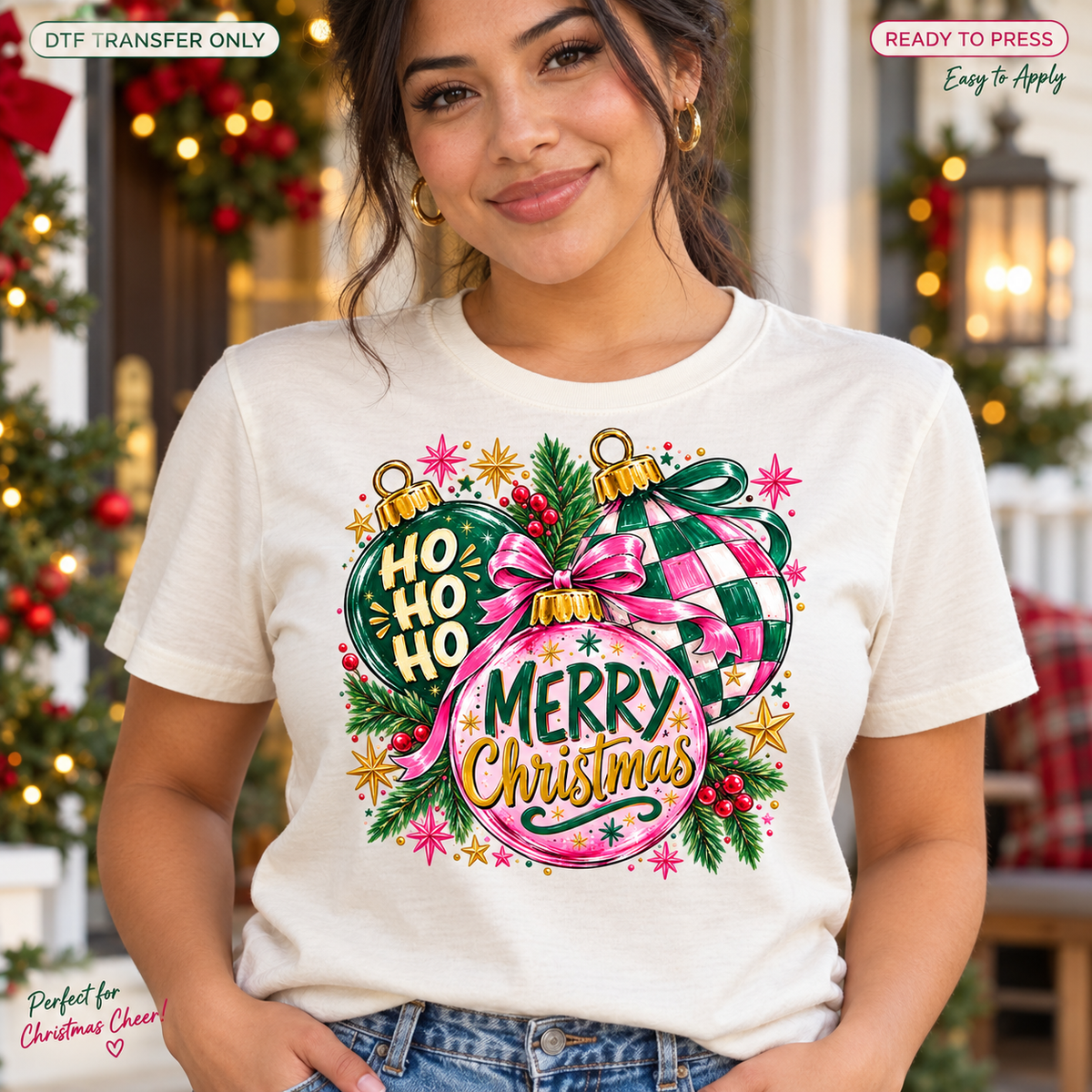 Lifestyle mockup of a woman wearing a cream shirt showing Merry Christmas and Ho Ho Ho ornaments with pink and green checked patterns, bows, and greenery. DTF transfer only; shirt not included.