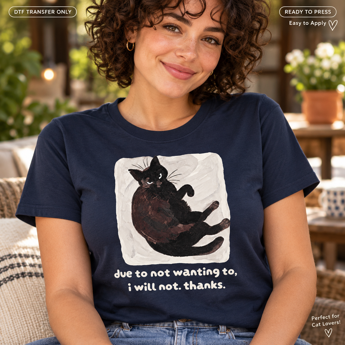 Lifestyle mockup of a woman wearing a navy shirt showing Black cat lounging on a pale backdrop above Due to Not Wanting To I Will Not Thanks wording. DTF transfer only; shirt not included.