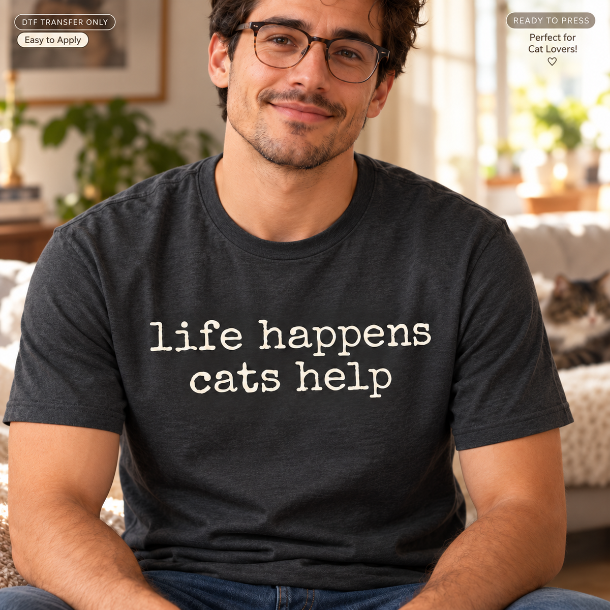Lifestyle mockup of a man wearing a charcoal shirt showing Life Happens Cats Help in simple white typewriter-style lettering. DTF transfer only; shirt not included.