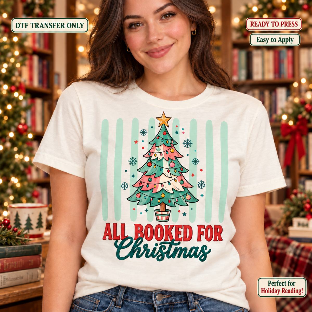 Woman wearing a cream shirt with a Christmas tree made from books and All Booked for Christmas lettering.