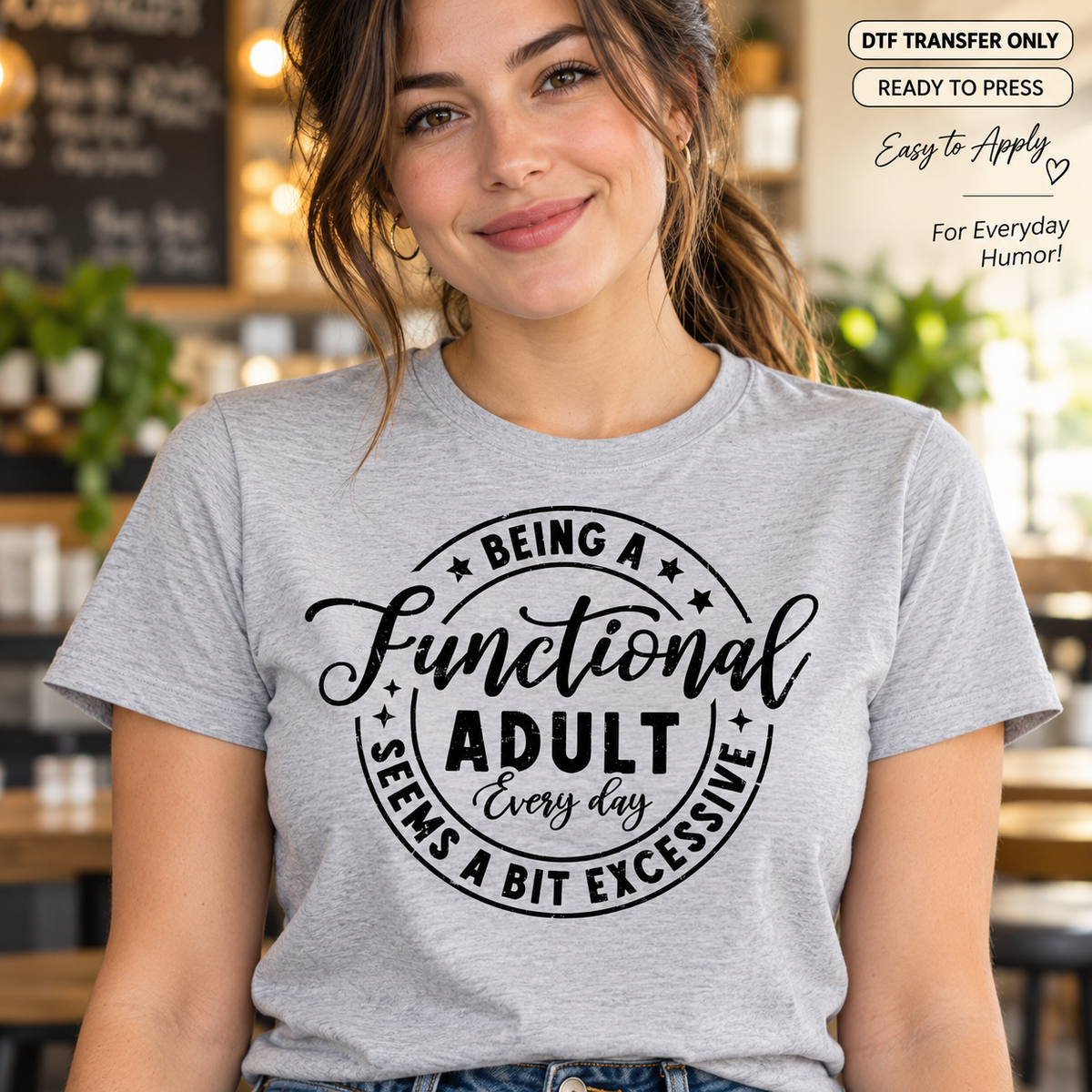 Woman wearing a heather gray shirt with black circular Being a Functional Adult Every Day Seems a Bit Excessive lettering.