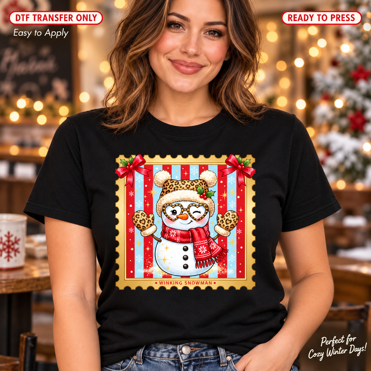 Woman in a black shirt with a winking snowman wearing leopard-pattern winter accessories inside a red and blue postage-stamp-style frame.