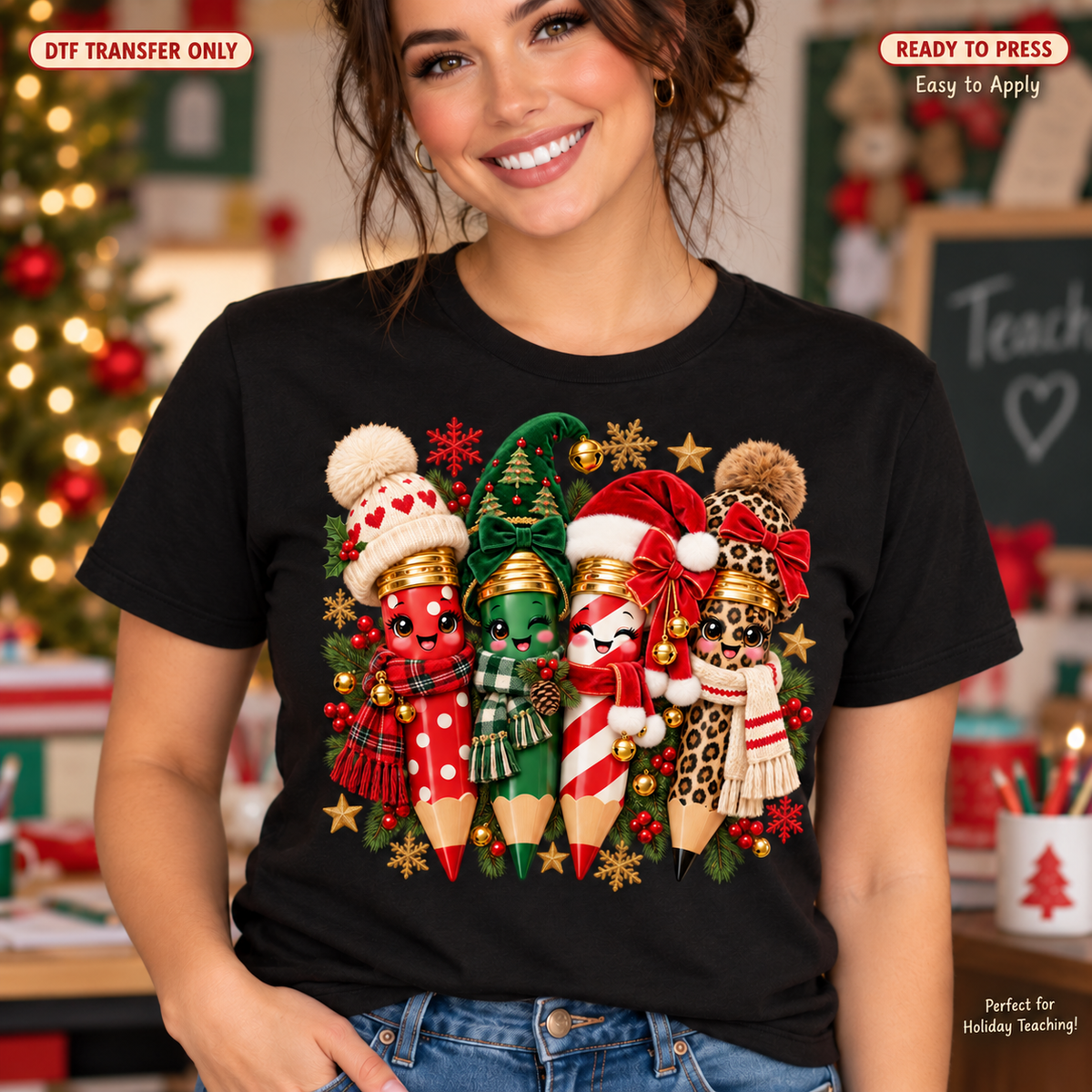 Woman wearing a black shirt with four smiling pencils in Christmas hats and scarves, accented with evergreen branches and snowflakes.