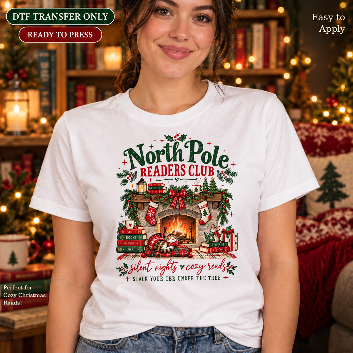 Woman wearing a white shirt with North Pole Readers Club lettering above a festive fireplace, books and Christmas greenery.