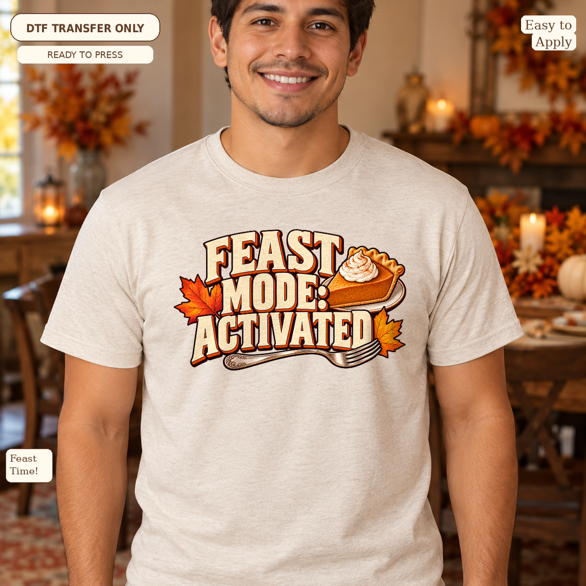 Man in a cream tee with Feast Mode Activated lettering, autumn leaves and a slice of pie.