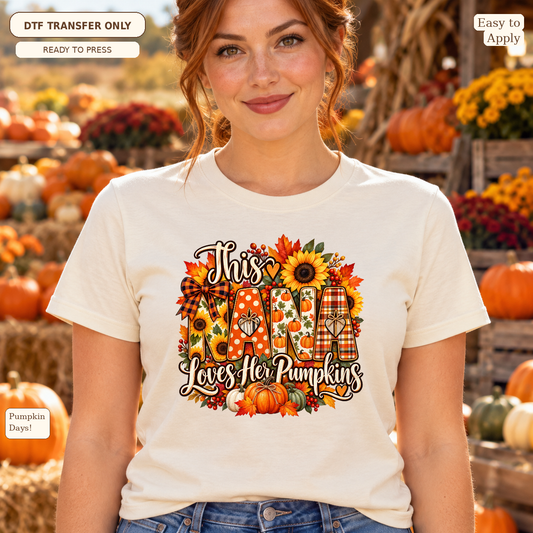 Woman wearing a cream tee with This Nana Loves Her Pumpkins text, patterned NANA letters, a sunflower and pumpkins.