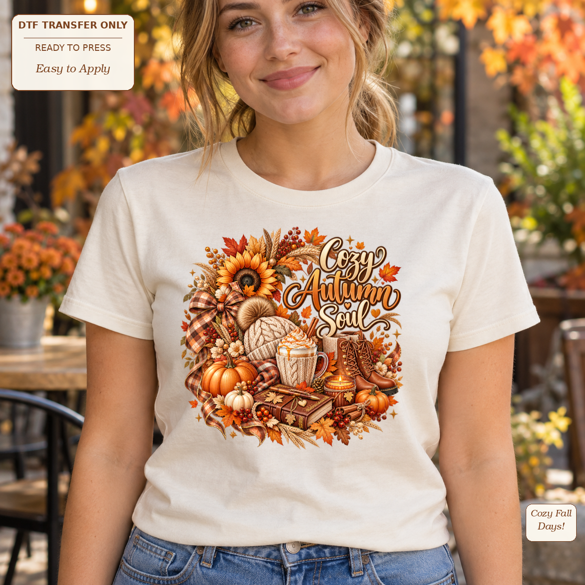 Woman wearing a cream tee with Cozy Autumn Soul script, books, a warm drink, pumpkins and sunflowers.